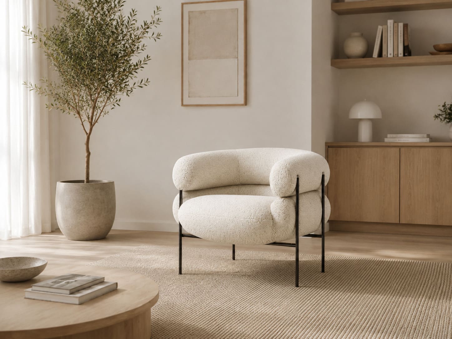 Lounge chair with a rounded cream boucle shell and a deep seat cushion, carried on a slim black metal frame with vertical posts, standing on a jute rug.